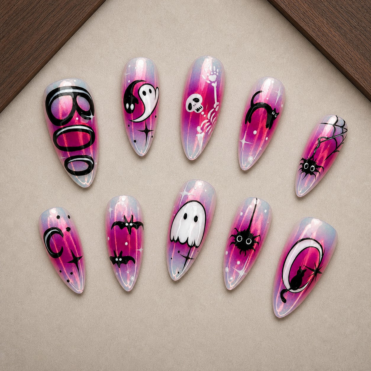 Chrome Boo Halloween press-on nail set displayed in a walnut tray — almond shape