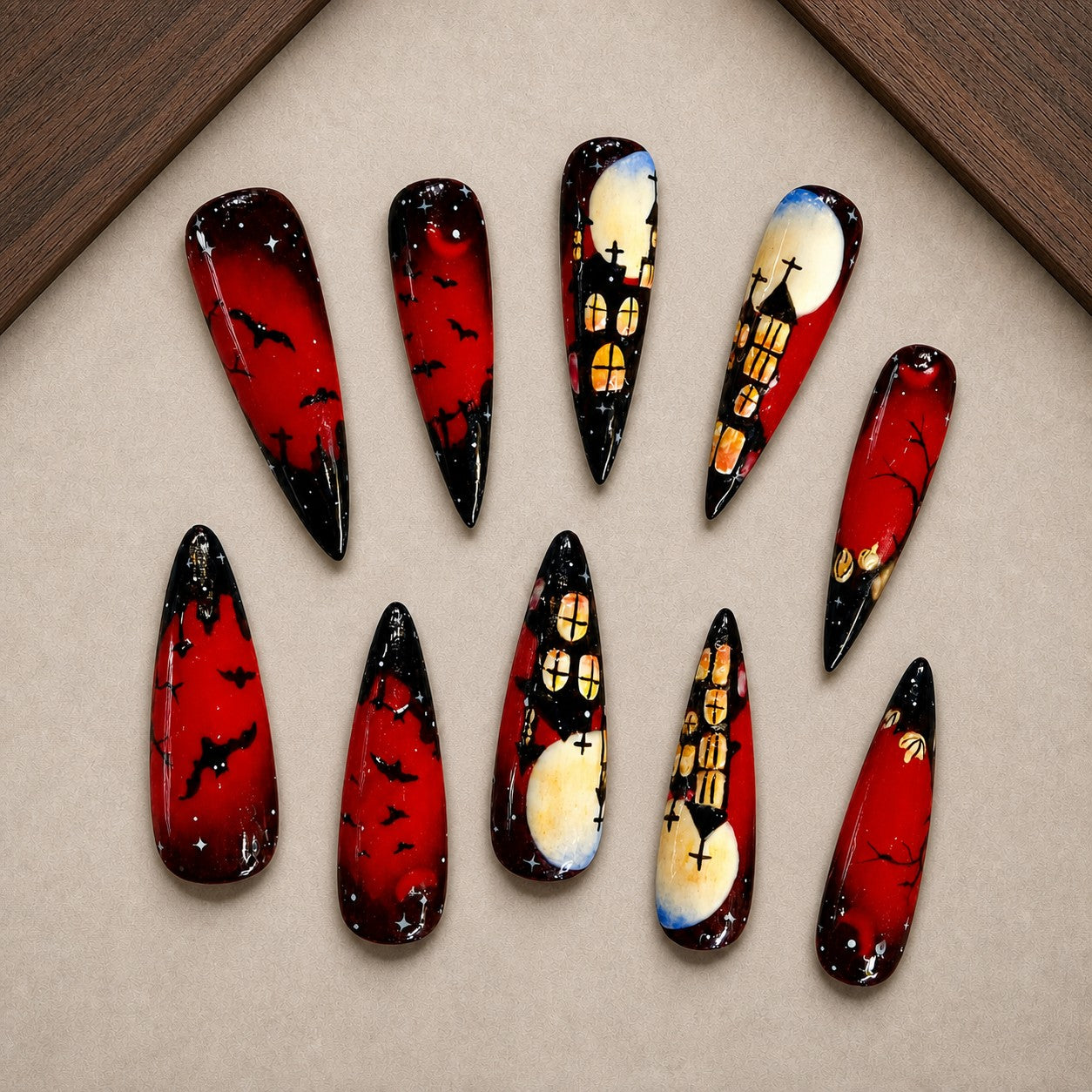 Crimson Keep Halloween press-on nail set displayed in a walnut tray — stiletto shape