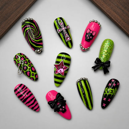 Neon Goth Pop press-on nail set displayed on a walnut tray, showing the mixed pink, black, and lime graphic designs.