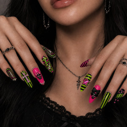 Hand model wearing the Neon Goth Pop press-on nails with hot pink, black, and lime graphic artwork.
