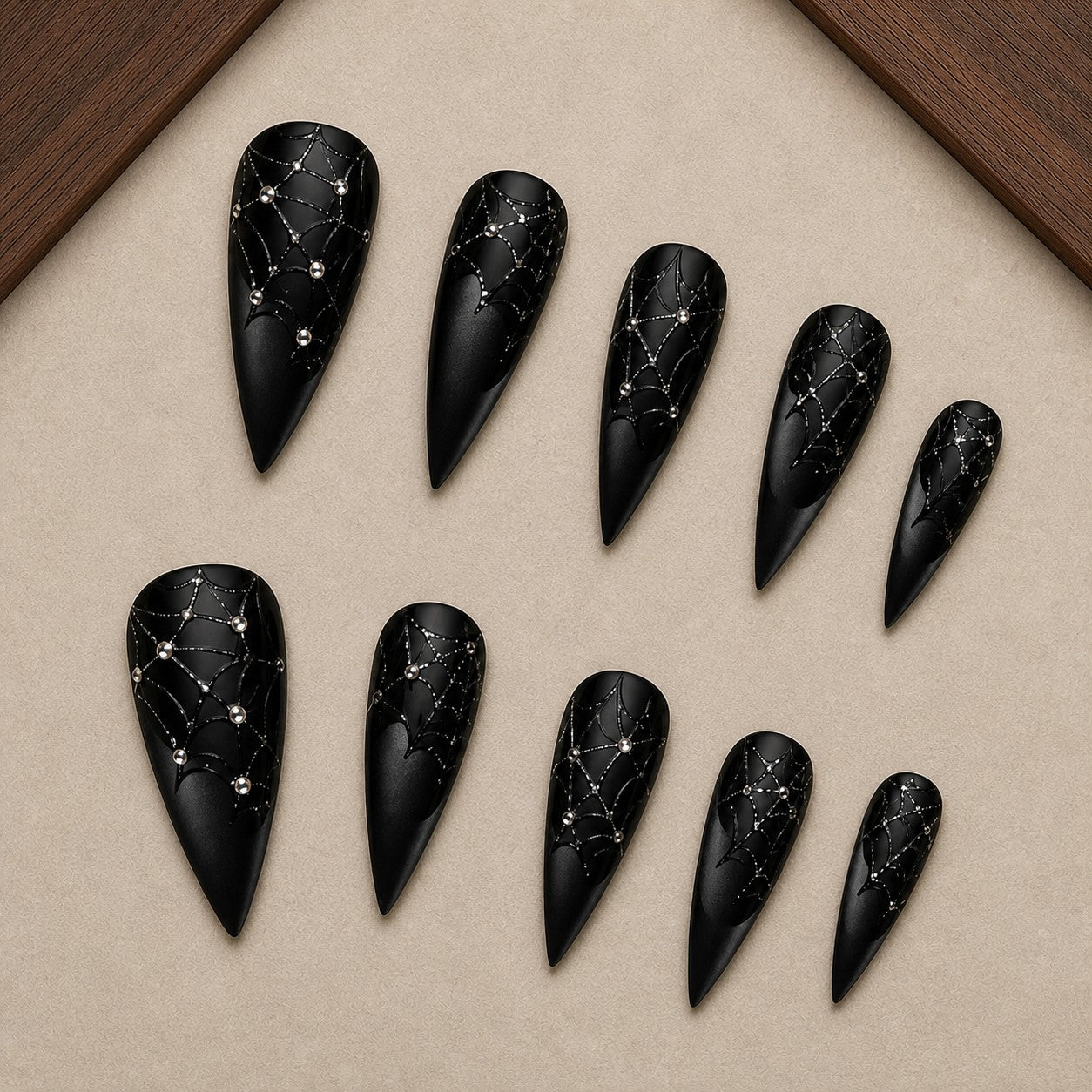 Diamond Web Noir Halloween press-on nail set displayed in a walnut tray — stiletto shape