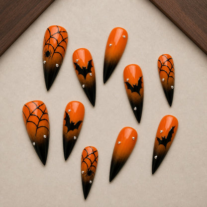 Ember Web Halloween press-on nail set displayed in a walnut tray — stiletto shape