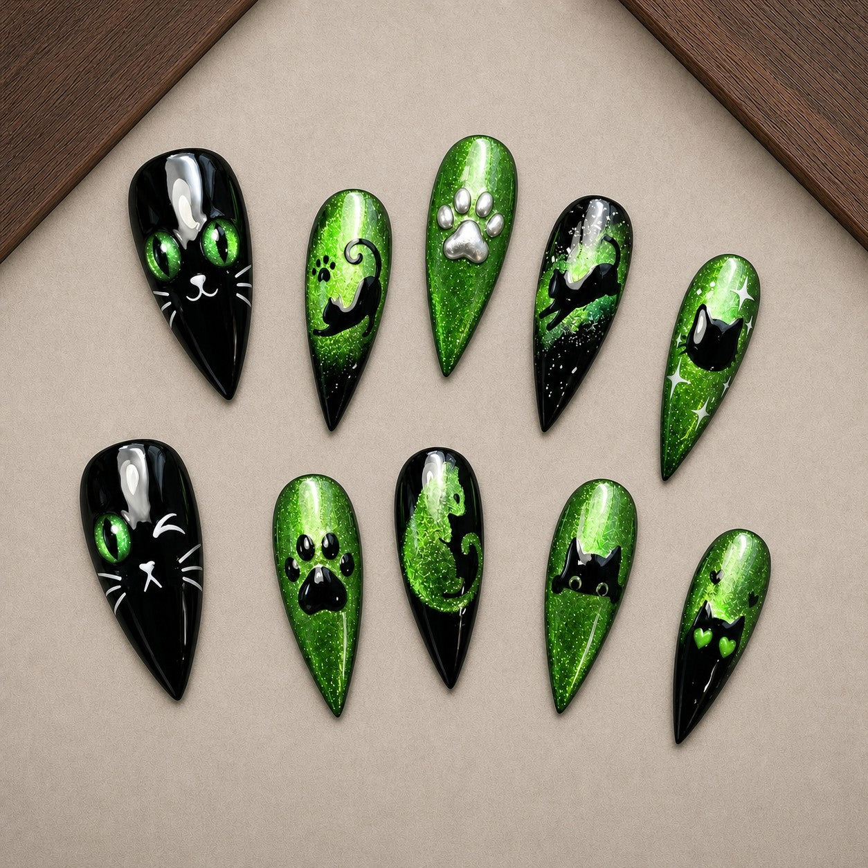 Emerald Familiar Halloween press-on nail set displayed in a walnut tray — stiletto shape