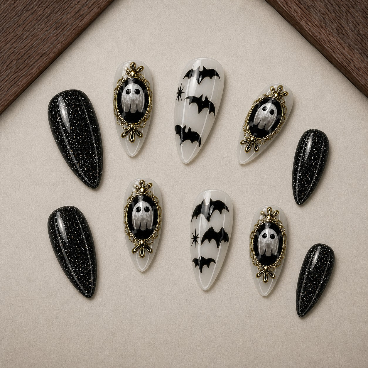 Haunted Cameo Halloween press-on nail set displayed in a walnut tray — almond shape