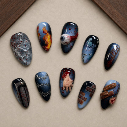 Horror Reel Halloween press-on nail set displayed in a walnut tray — almond shape