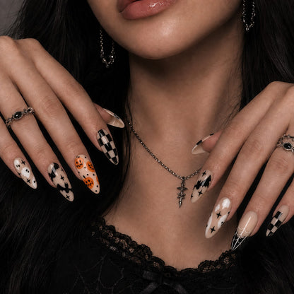Latte Boo Halloween press-on nails in almond shape worn on model hand — neutral, pumpkin, ghost nail art