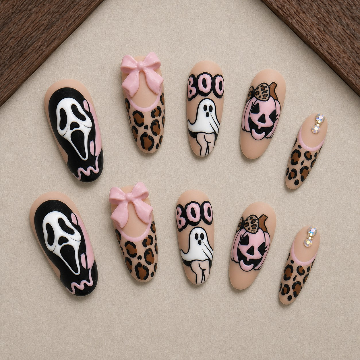 Leopard Scream Halloween press-on nail set displayed in a walnut tray — almond shape