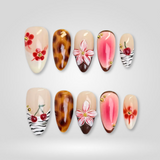 All Too Well gold rose and cross press-on nails on nude ombré base