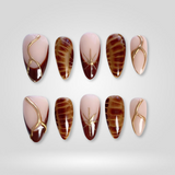 Boho Luxe press-on nails — nude oval with bronze starburst and crystal details