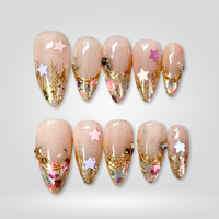 Celestial Dream gold glitter press-on nails on almond shape