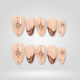 Bronze Star nude oval press-on nails — starburst pattern