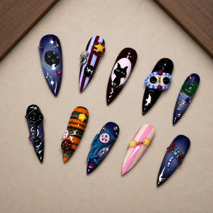 Midnight Curio Halloween press-on nail set displayed in a walnut tray — stiletto shape