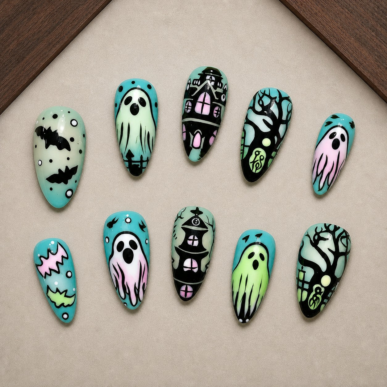 Pastel Manor Halloween press-on nail set displayed in a walnut tray — almond shape