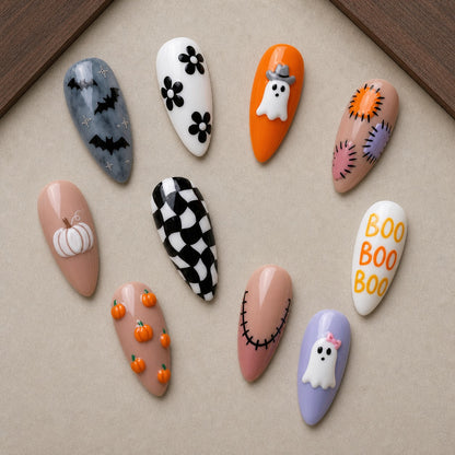 Patchwork Boo Halloween press-on nail set displayed in a walnut tray — almond shape