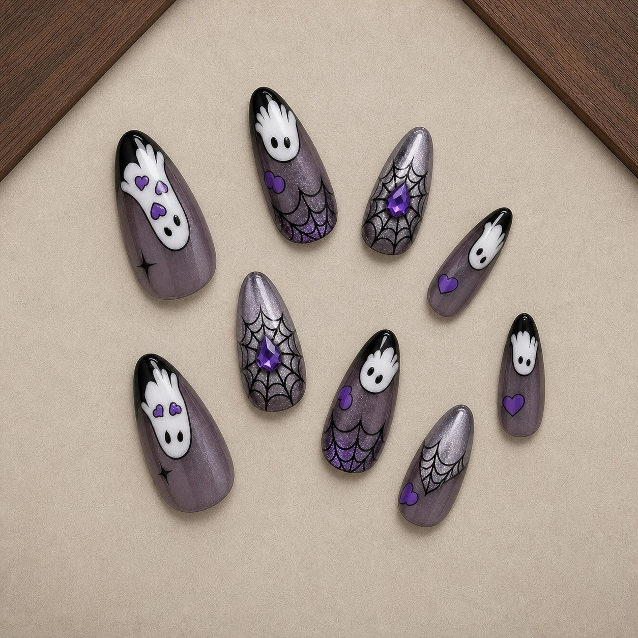 Phantom Hands Halloween press-on nail set displayed in a walnut tray — almond shape