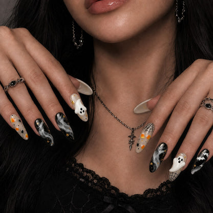 Phantom Smoke Halloween press-on nails in almond shape worn on model hand — marble, bat, ghost nail art