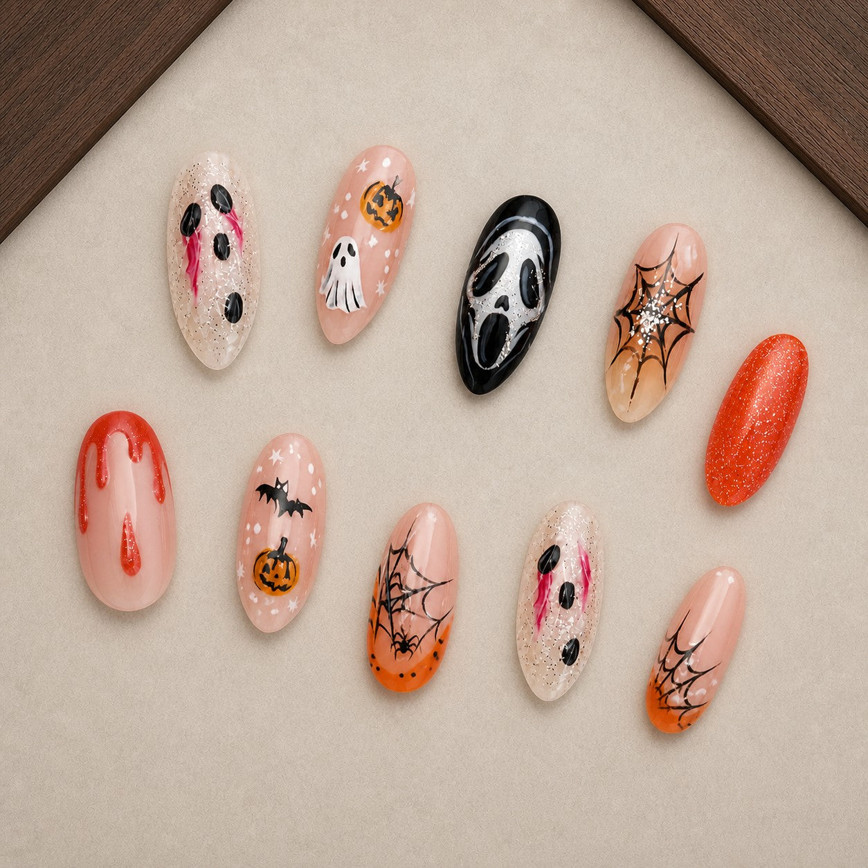 Sheer Scream Halloween press-on nail set displayed in a walnut tray — almond shape