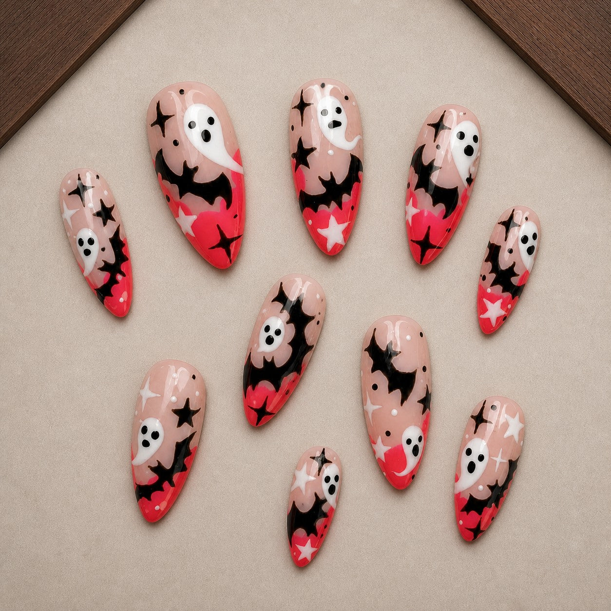 Starlit Boo Halloween press-on nail set displayed in a walnut tray — almond shape
