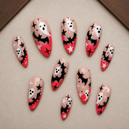 Starlit Boo Halloween press-on nail set displayed in a walnut tray — almond shape
