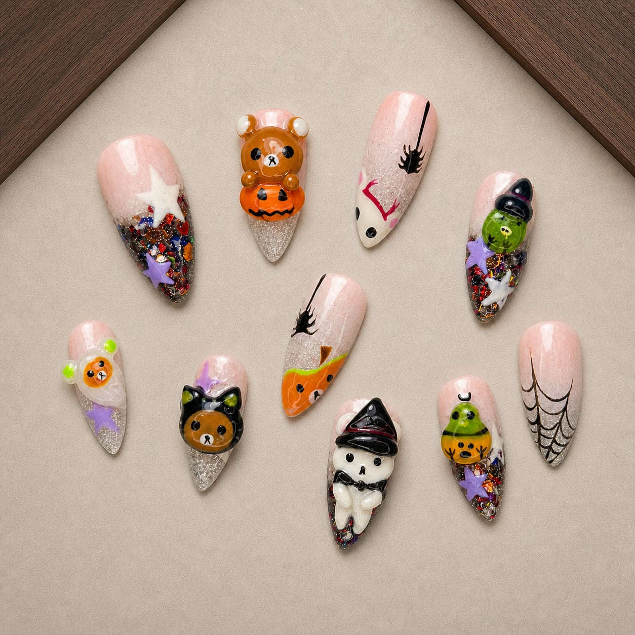 Teddy Treats Halloween press-on nail set displayed in a walnut tray — almond shape