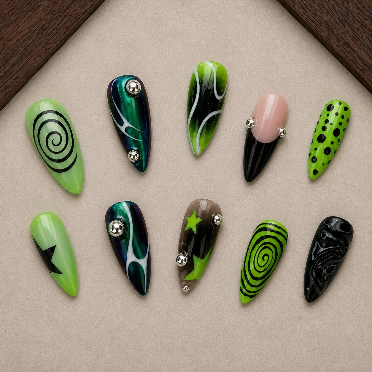 Toxic Swirl Halloween press-on nail set displayed in a walnut tray — almond shape