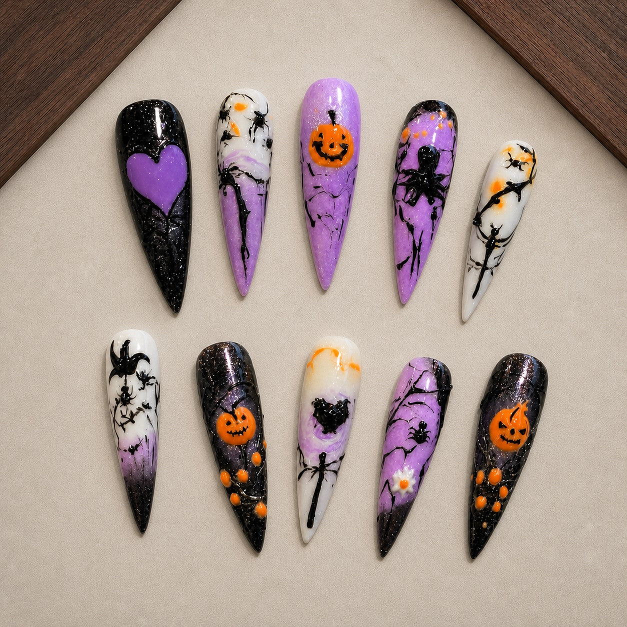 Violet Hollow Halloween press-on nail set displayed in a walnut tray — stiletto shape