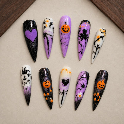 Violet Hollow Halloween press-on nail set displayed in a walnut tray — stiletto shape