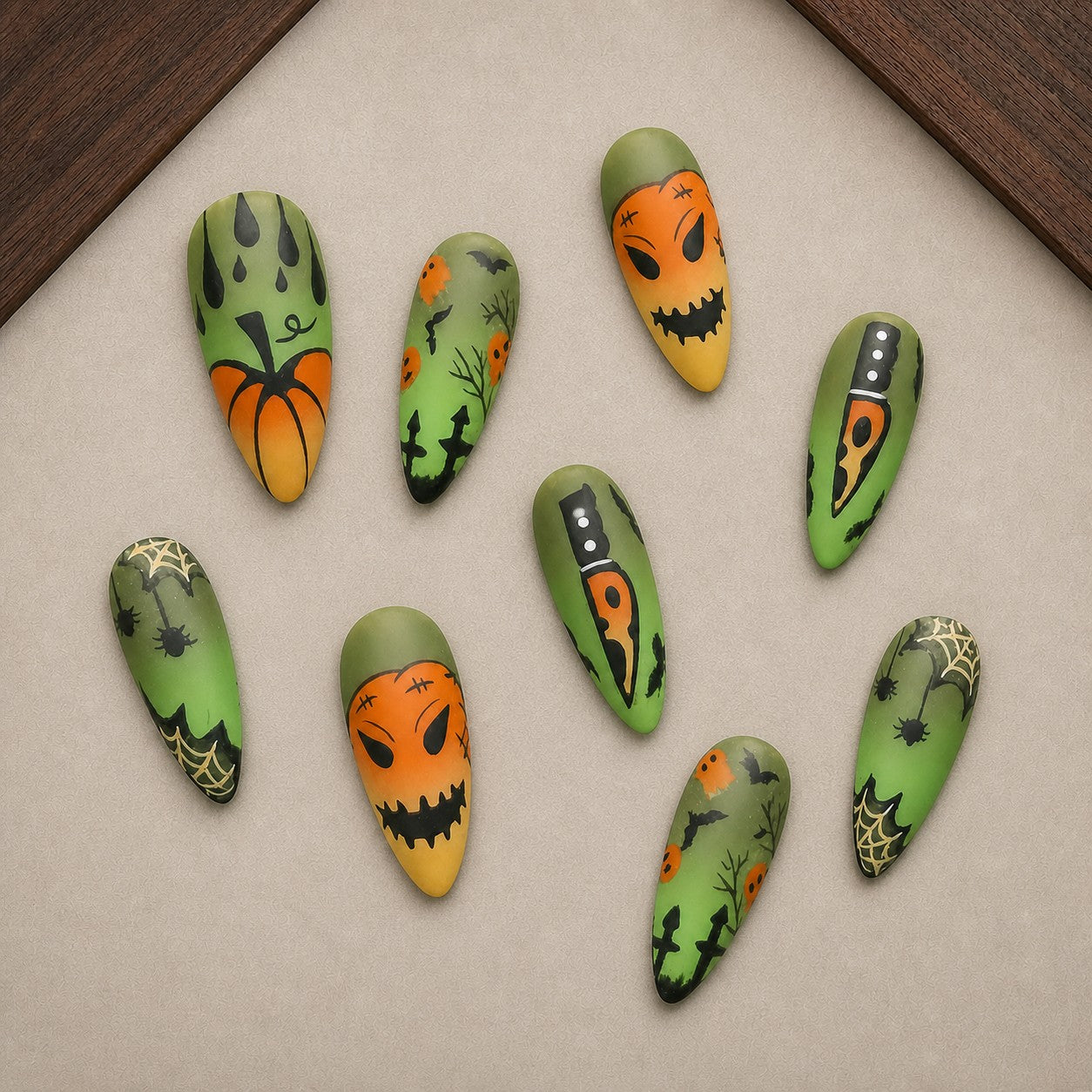 Wicked Patch Halloween press-on nail set displayed in a walnut tray — almond shape