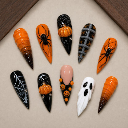 Widow's Harvest Halloween press-on nail set displayed in a walnut tray — stiletto shape