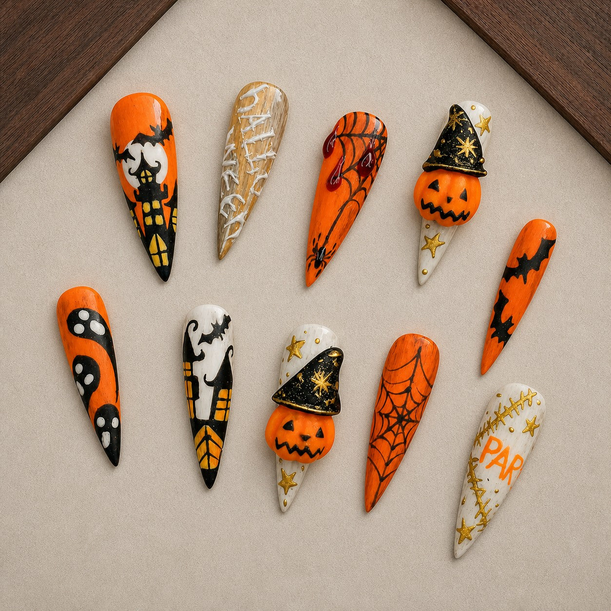 Witch's Story Halloween press-on nail set displayed in a walnut tray — stiletto shape